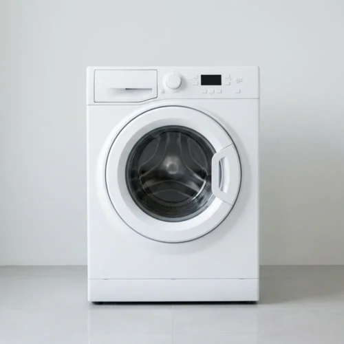 White front-load washing machine with a round glass door in a bright home laundry area.